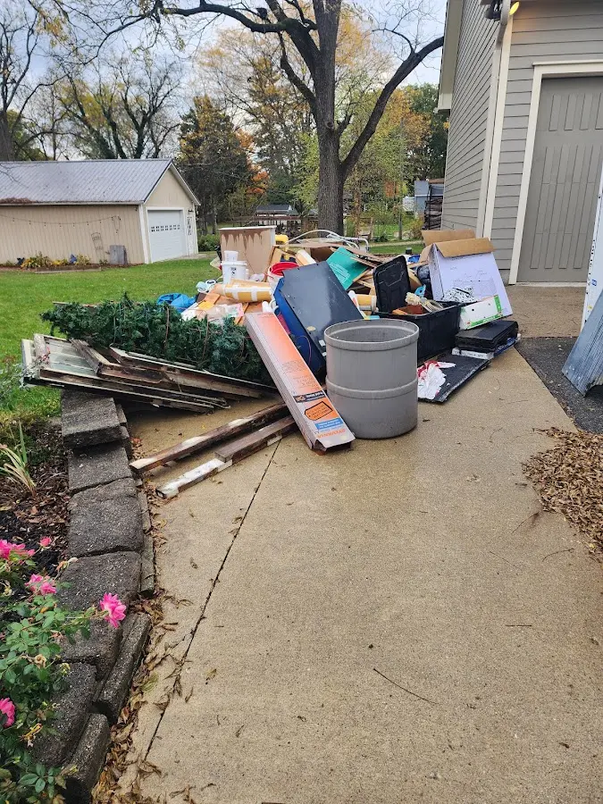 Dumpster being loaded with debris for Estate Cleanout Dumpster Rental in Kenmore